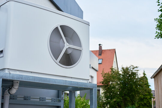 Outdoor heat pump unit installed next to residential building