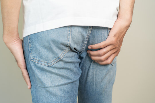 men feeling itching and scratching his crotch