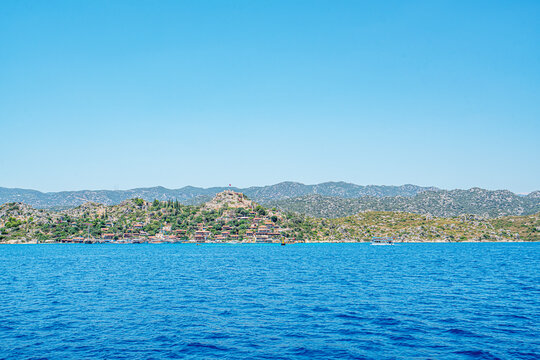 Turquoise waters and ancient Lycian coast of Kekova Island during a boat cruise in Antalya, Turkey.