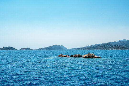Turquoise waters and ancient Lycian coast of Kekova Island during a boat cruise in Antalya, Turkey.