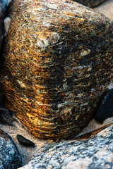 Detailed texture of a golden rock in the sand © Thales