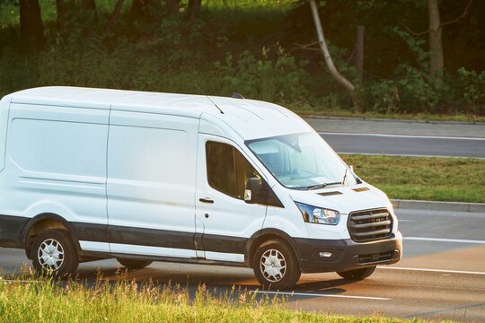 Cargo van transportation in a green roadside setting