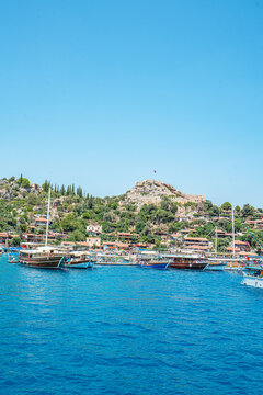 Turquoise waters and ancient Lycian coast of Kekova Island during a boat cruise in Antalya, Turkey.