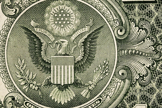 Macro detail of the Great Seal on a one-dollar banknote. Engraved eagle, shield, stars and ornamental linework in close-up.