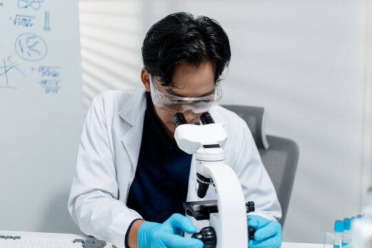 Scientists perform laboratory research using microscopes, test tubes, and modern scientific equipment to analyze samples, representing biotechnology, healthcare, diagnostics, and medical innovation.