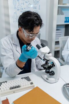 Scientists perform laboratory experiments using microscopes, pipettes and test tubes while analyzing samples in modern research laboratory, representing biotechnology, diagnostics and medical science.