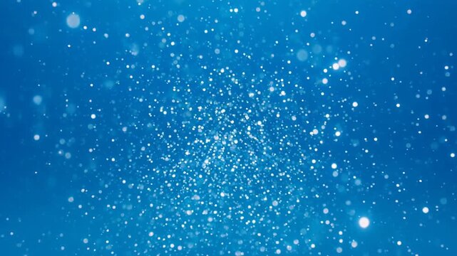 Deep blue ocean with sparkling underwater particles and light rays during daytime