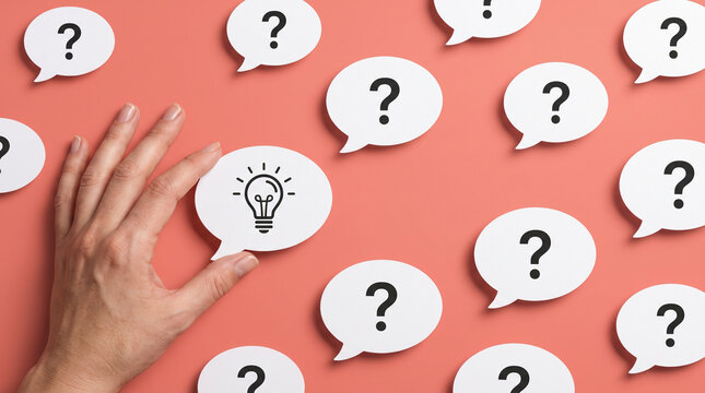 Finding clarity concept showcasing hand selecting successful lightbulb idea from multiple question marks on vibrant pink background