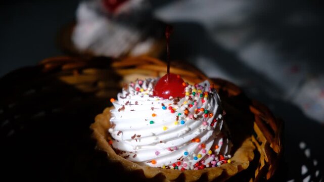 Cupcakes, sand baskets with cream with Cherry Topping. Dusk. Sunset sunlight and atmospheric mood. Cupcakes with white pink meringues on top and chocolate, muffins