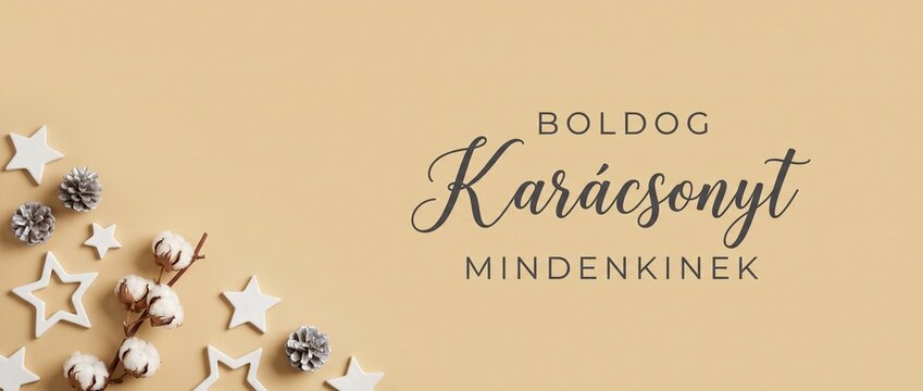 Hungarian Christmas background flat lay with stars, cotton, and pine cones featuring Boldog Karacsonyt text, offering an elegant minimalist beige holiday greeting banner template for festive celebrati