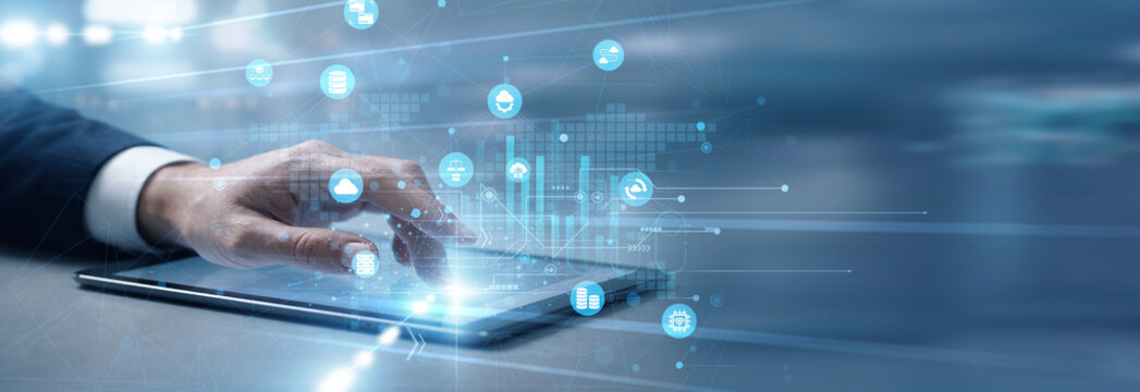 IT professional handling remote systems, touch tablet and access network resources for Cloud Computing services, ensuring scalability, storage efficiency, and flexible digital infrastructure.