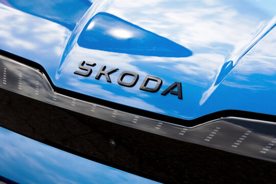 Koprivnice, Czech Republic, Czechia - 31 May, 2026: Skoda auto - logo and brand of car manufacturer. Detail of gray vehicle with metallic paint. Shallow focus.	
