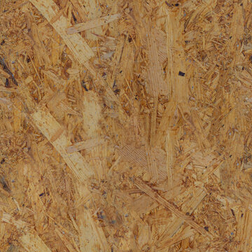 Seamless texture of oriented strand board (OSB). Close-up of a wooden pressed panel background with a chipboard pattern and copy space