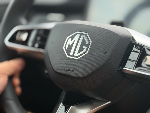 Close-up of an mg car steering wheel with logo and driver hand inside a modern vehicle interior MG S5 EV electric Poland, Pszczyna, 3.08.2026 
