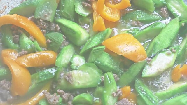 Stir-fried luffa with minced pork on pan.