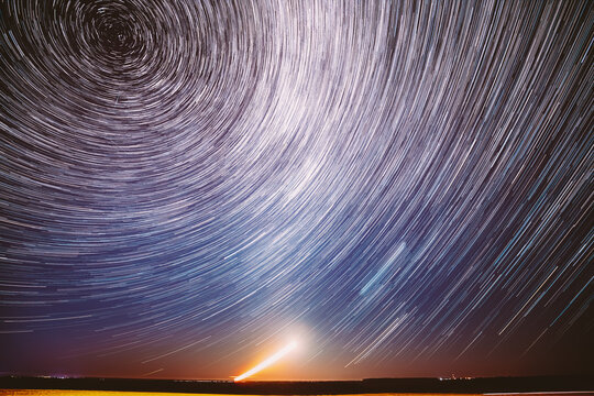 Moonrise Sky Natural Background. Unusual Amazing Stars Effect In Sky. Trace Of Moon. Spin Of Star And Meteoric Trails On Night Sky. Large Exposure. Imagination, Fantasy, Illusion, Dream View. Flight