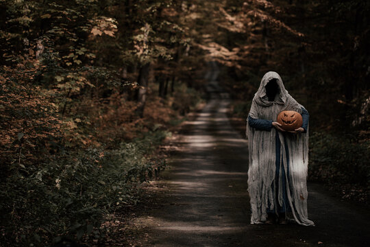 Spooky and scary Halloween themed image in a dark forest. 