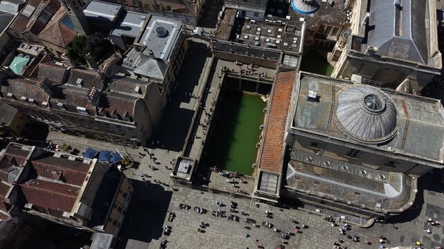 Tourists visiting the historic roman baths in bath, england. Drone aerial Orbit shot