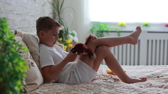 Cute preschool child, boy, playing with toys in a sunny living room