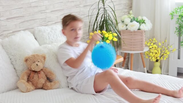 Cute preschool child, boy, playing with toys in a sunny living room