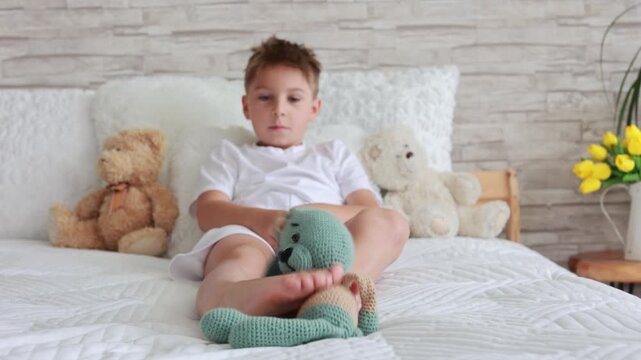 Cute preschool child, boy, playing with toys in a sunny living room