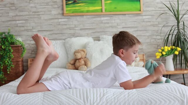 Cute preschool child, boy, playing with toys in a sunny living room