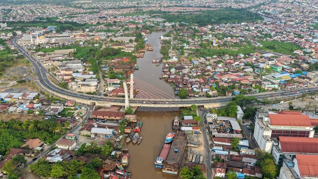 A view of Banjarmasin city and the Alalak River Bridge (or Basit Handil Bakti Bridge) in the late afternoon