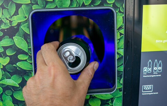 Returning Empty Bottles and Cans at a Supermarket Recycling Machine &ndash; Deposit Return, Recycling and Sustainability Concept