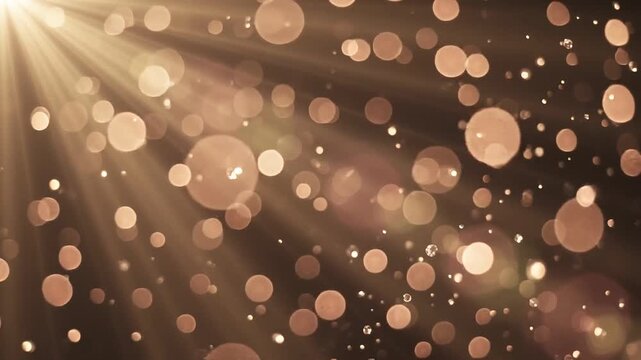 Golden bokeh particles and sparkling diamonds falling through warm light rays on a dark background, shimmering luxury abstract loop
