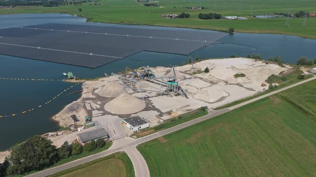 Aerial view of a sand dredging operation and floating solar panels