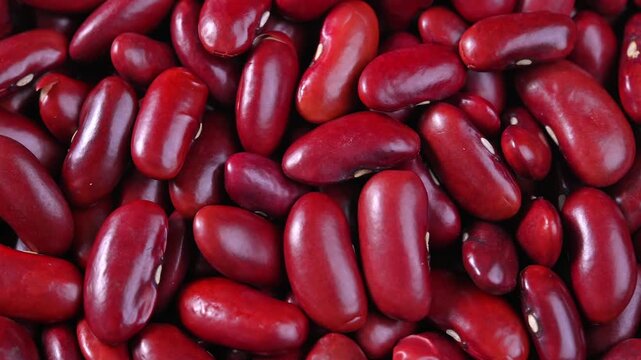 Close-up view of fresh red beans, showcasing their vibrant red color, smooth texture, and natural details. Suitable for food, nutrition, healthy eating, cooking, and agricultural concepts.