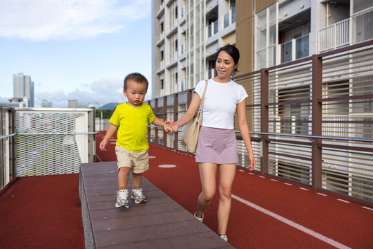 Mother and child walking outdoors together