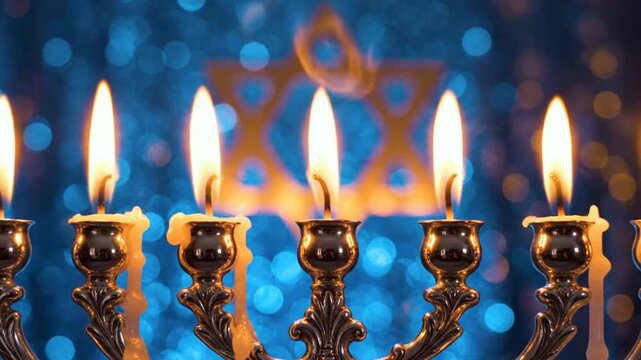 Burning Hanukkah menorah candles with blue bokeh and Star David