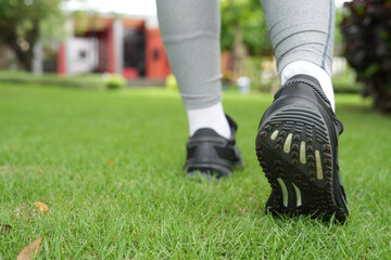Fototapeta premium Woman is walking exercise at the park