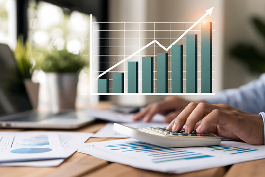 photorealistic close up of financial analyst hands working with documents and calculator while a digital rising bar chart appears above a wooden desk, investment growth concept, modern business