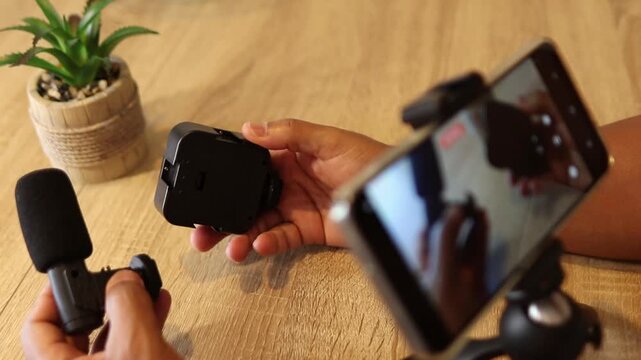Content creator assembling smartphone vlogging rig