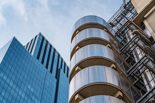 View of the iconic Lloyd's building with its external service ducts and a modern glass skyscraper in the City of London, England, United Kingdom.