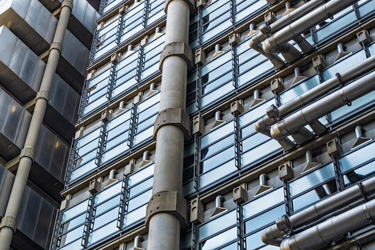 View of the iconic Lloyd's building, showcasing its distinctive high-tech architectural style with exposed external pipes, glass panels, and structural columns London, England, United Kingdom.