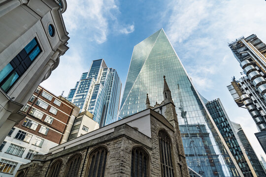 View of the historic St. Helen's Bishopsgate church juxtaposed with the modern glass facade of the Scalpel skyscraper in the City of London, London, England, United Kingdom.