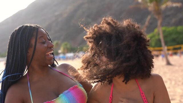 Happy multiracial girls having fun hugging each other on the beach during summer vacation - Holiday, female friendship and diversity concept	
