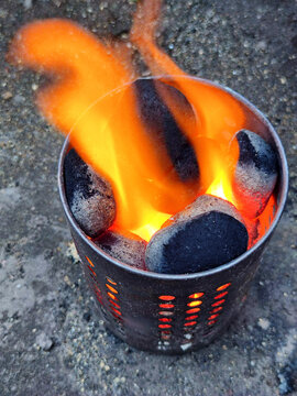 Lit coal briquettes