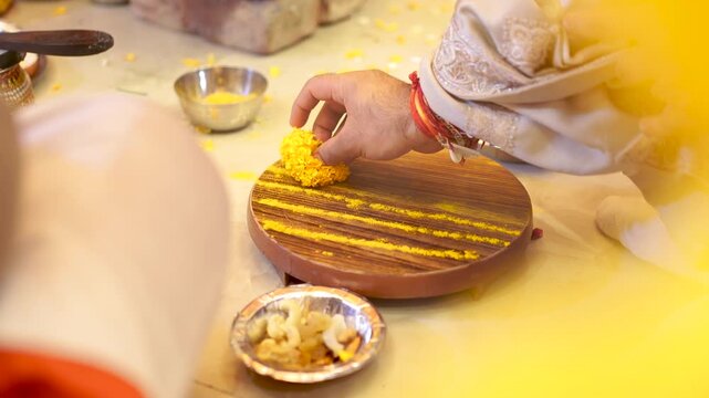 Traditional Indian wedding ritual with turmeric paste on wooden board in Delhi NCR India
