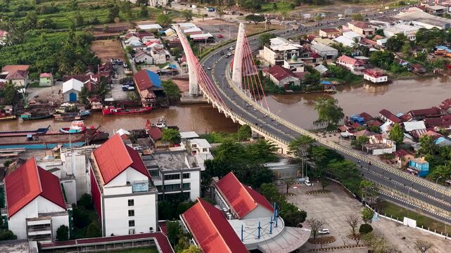 A view of Banjarmasin city and the Alalak River Bridge (or Basit Handil Bakti Bridge) in the late afternoon