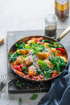 Potato gnocchi with tomato sauce and spinach and basil and parmesan cheese