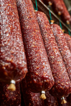 Salamis hang in a ripening room