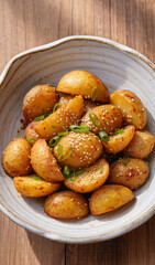 Fototapeta premium Crispy Golden Baby Potatoes with Herbs and Sesame Seeds