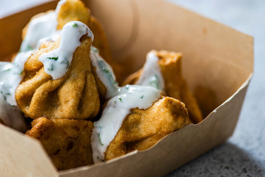 Georgian fried mini khinkali with sour cream sauce