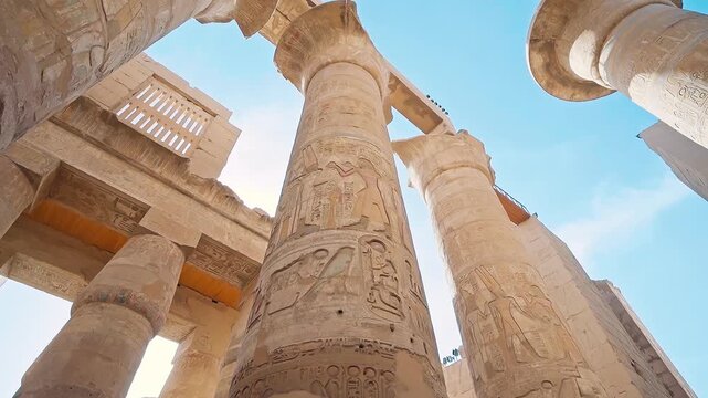 Pillars of the majestic temple of Karnak in Luxor, Egypt. Karnak Temple is dedicated to the temple complex of Ancient Egypt in honor of the god Amun-Ra, his wife Mut and son Khons. Thebes, Karnak.