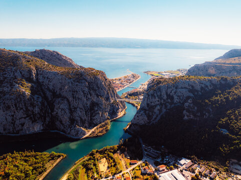Aerial view of Omis city and the Cetina river canyon meeting the Adriatic sea, featuring historic Mirabella fortress and mountains, Dalmatia, Croatia