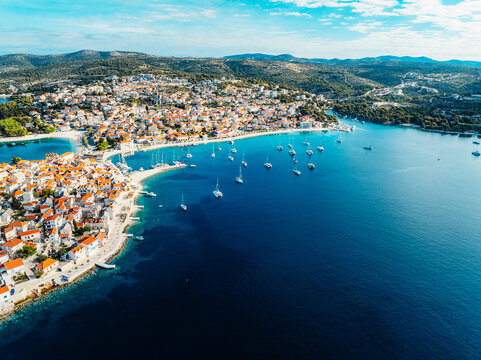 Aerial view of the historic town of Primosten on a peninsula, surrounded by crystal clear turquoise Adriatic sea, Dalmatia, Croatia.